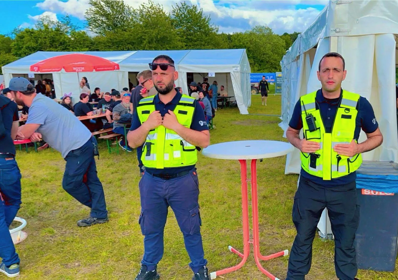 Two Square Security officers on a festival site with marquees